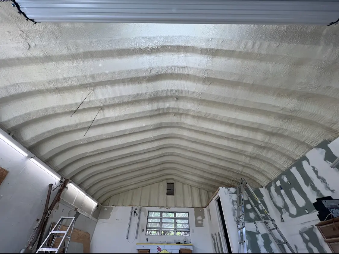 Spray polyurethane foam applied to the underside of a metal roof deck in Hollis